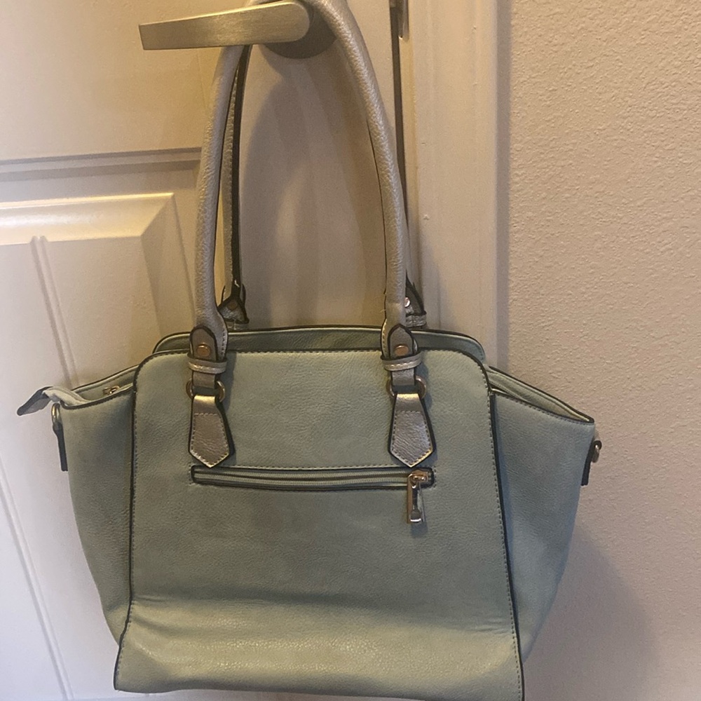 Light Blue gently used purse with silver embellishments & gold zippers.